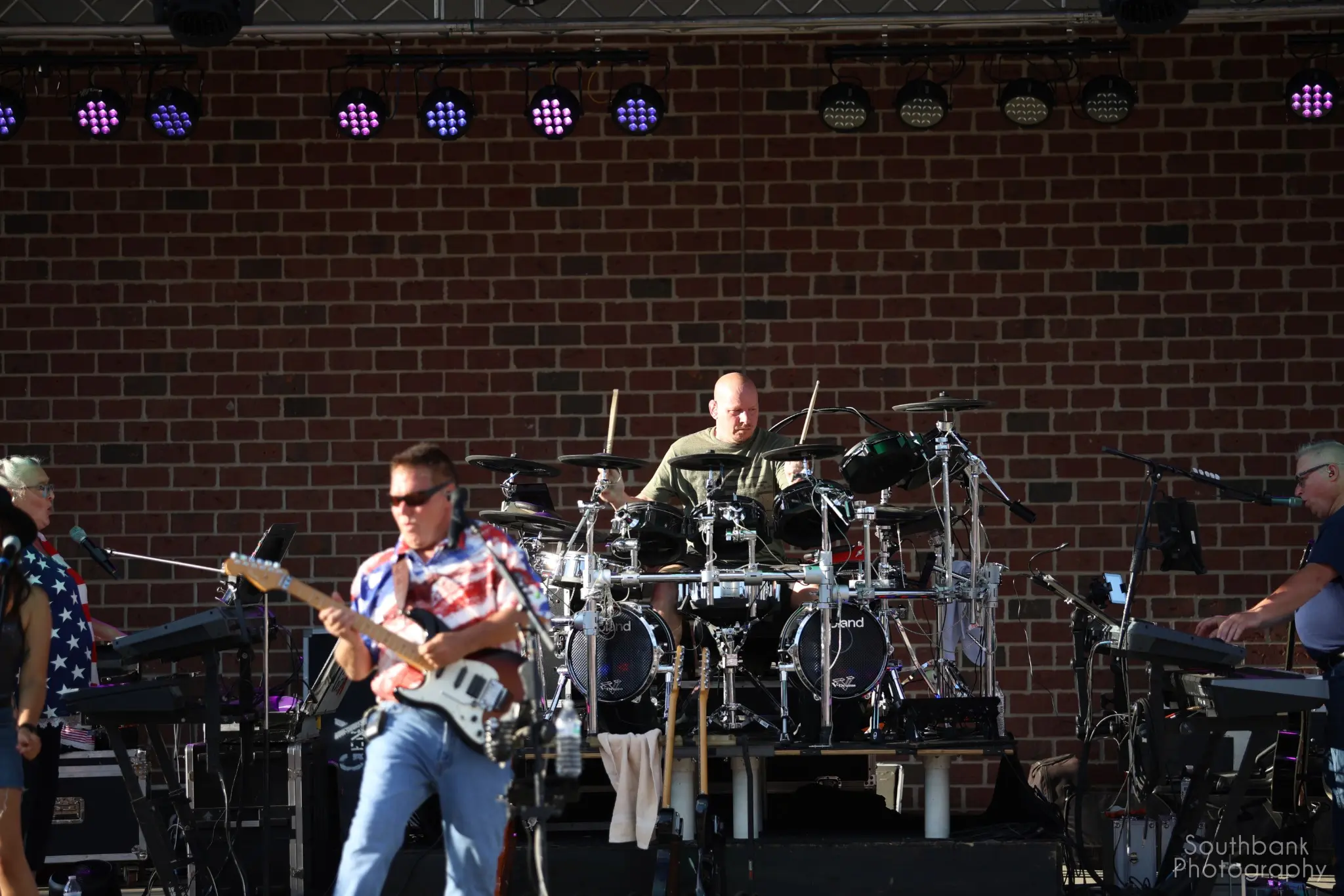 Guitarist and drummer performing with GenX