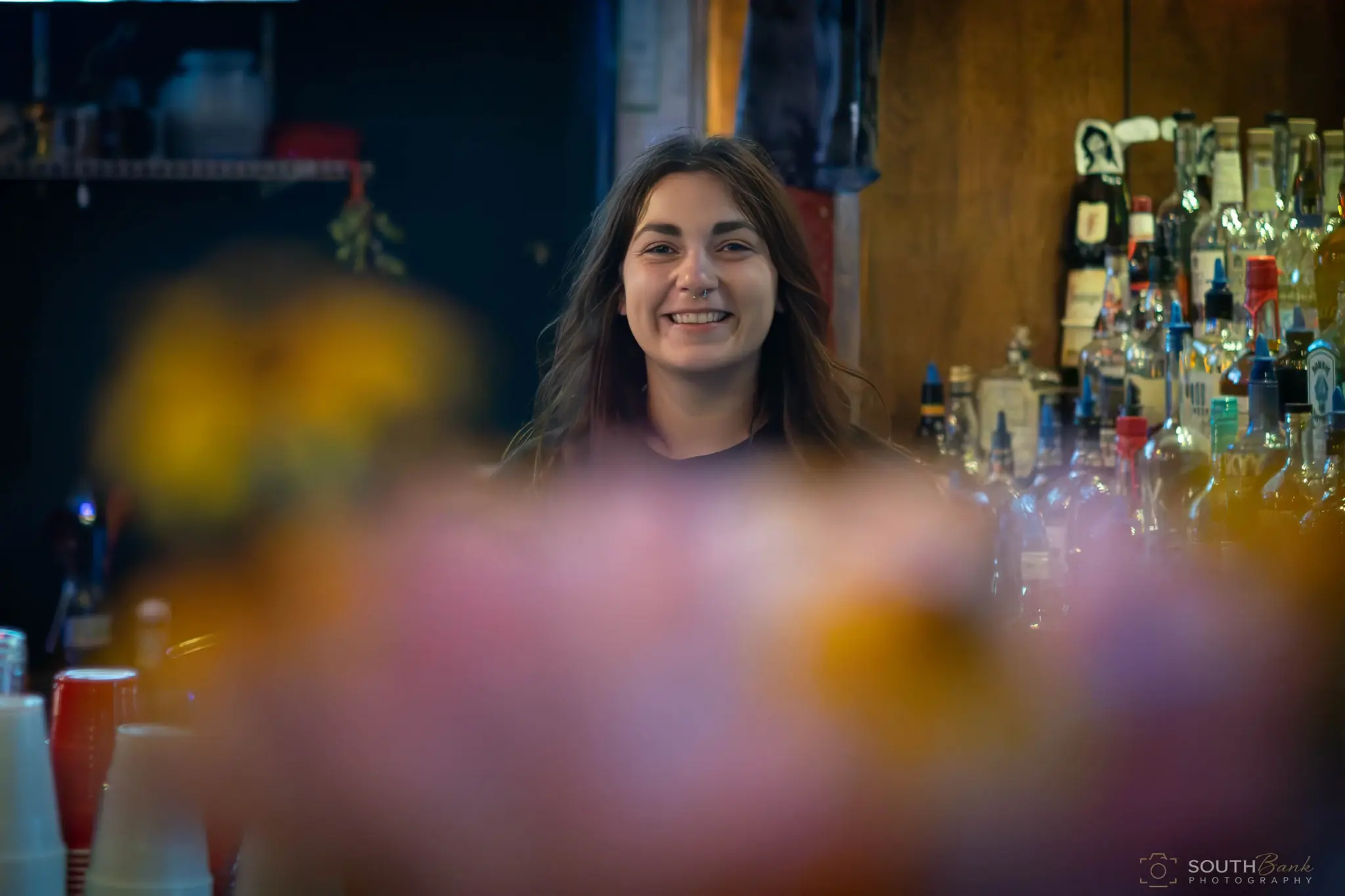 Venue team member photographed through colorful foreground bokeh