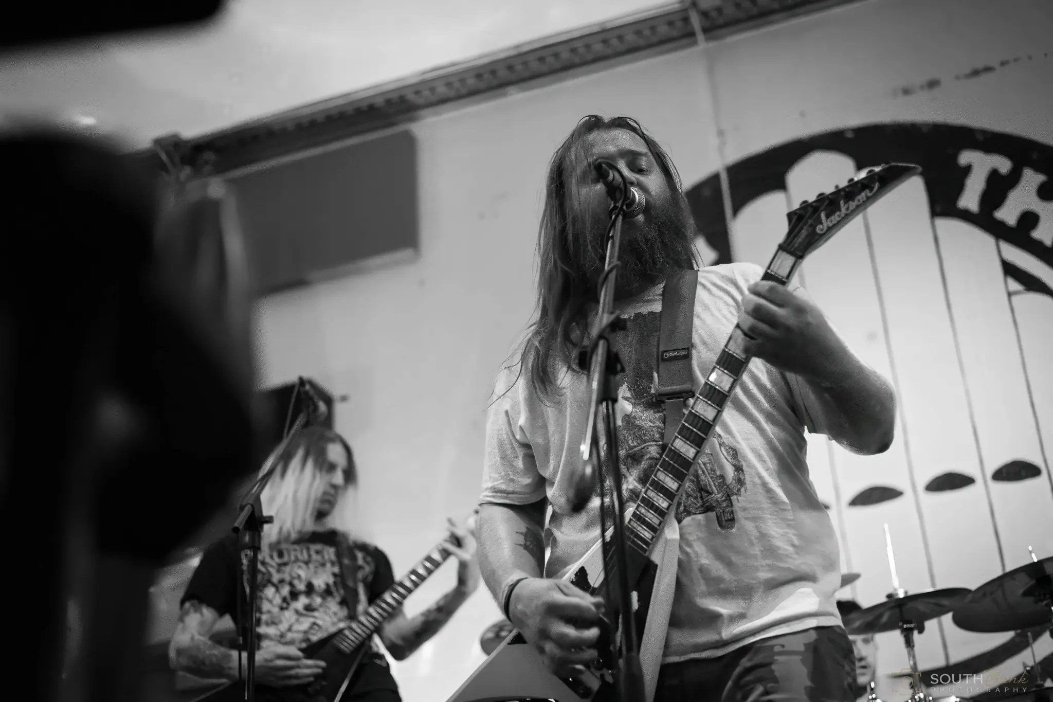 Guitarist photographed in black and white during an energetic performance