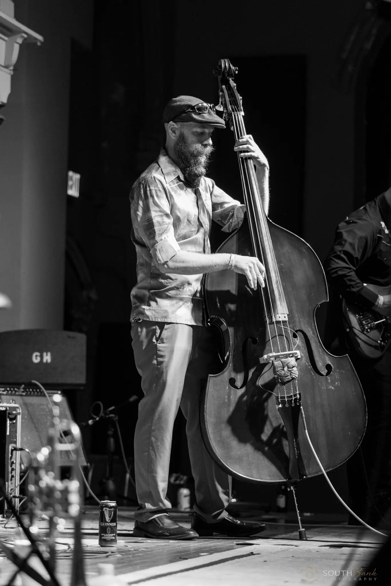 Upright bass player performing in black and white