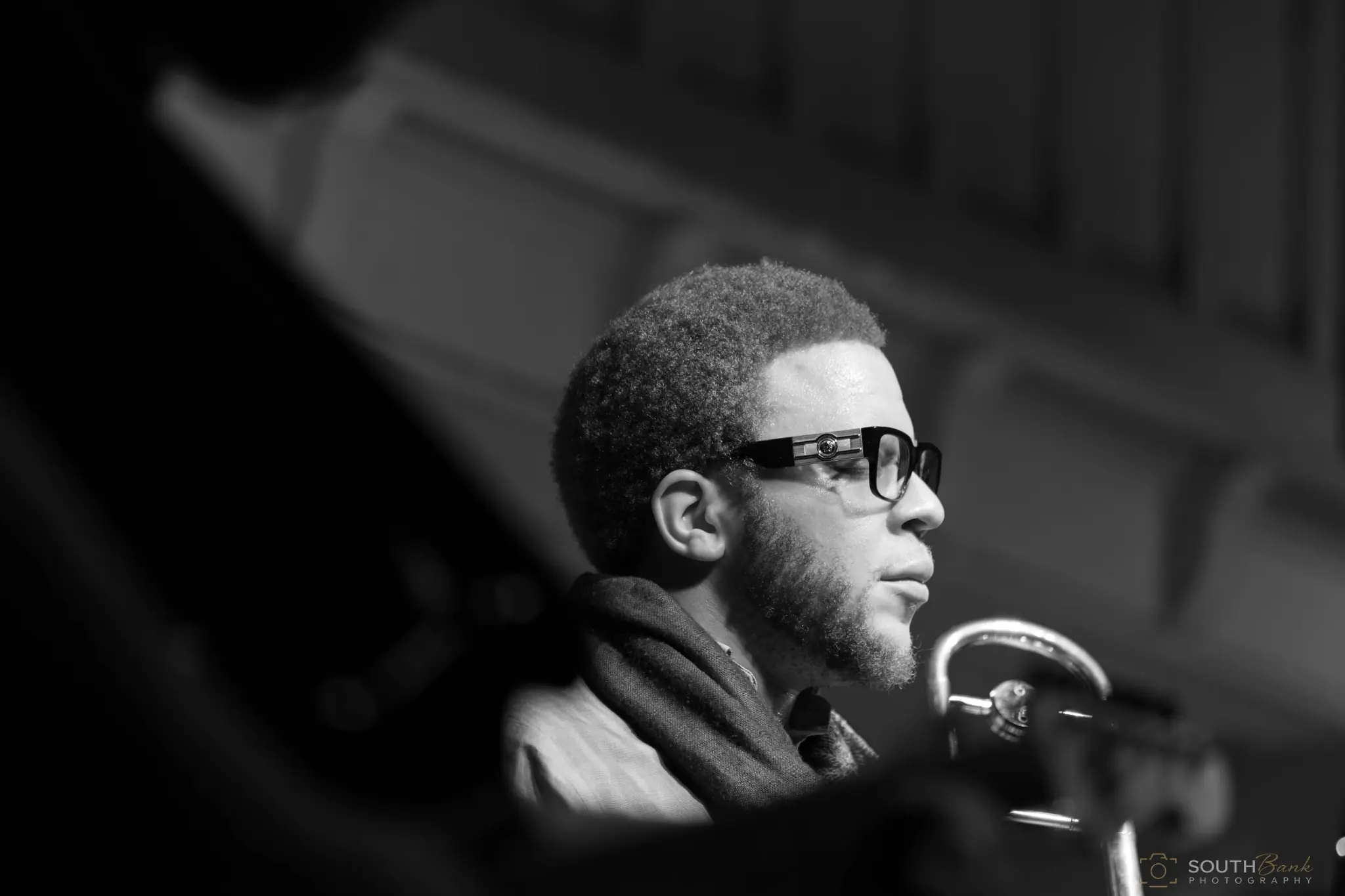 Musician wearing sunglasses photographed in black and white during a live set