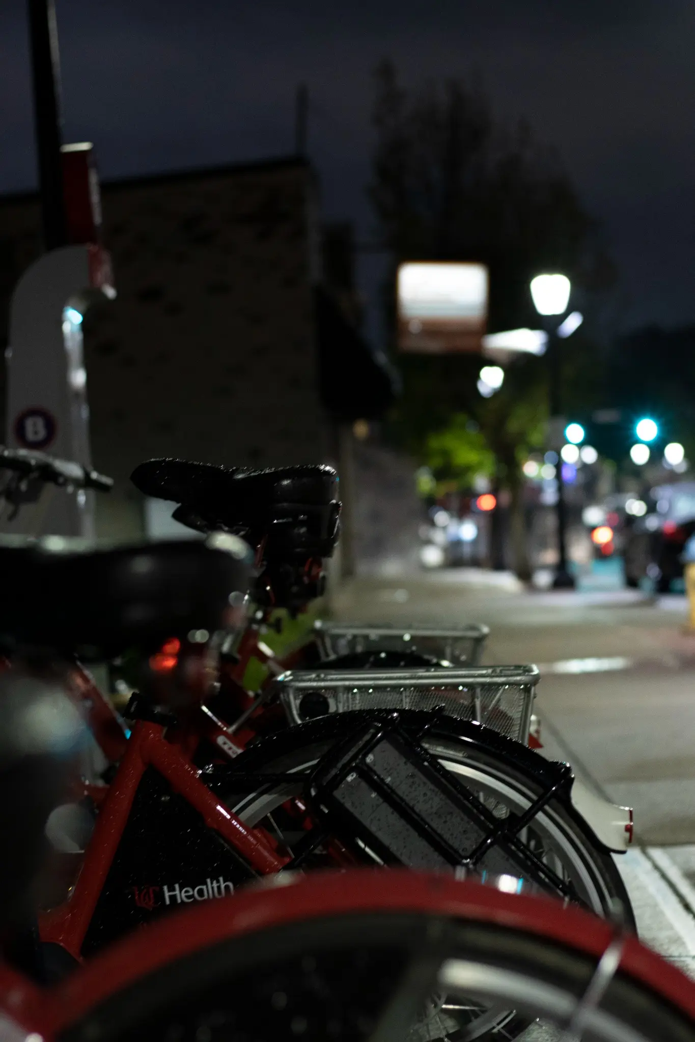 Bicycles parked along a Bellevue street at night